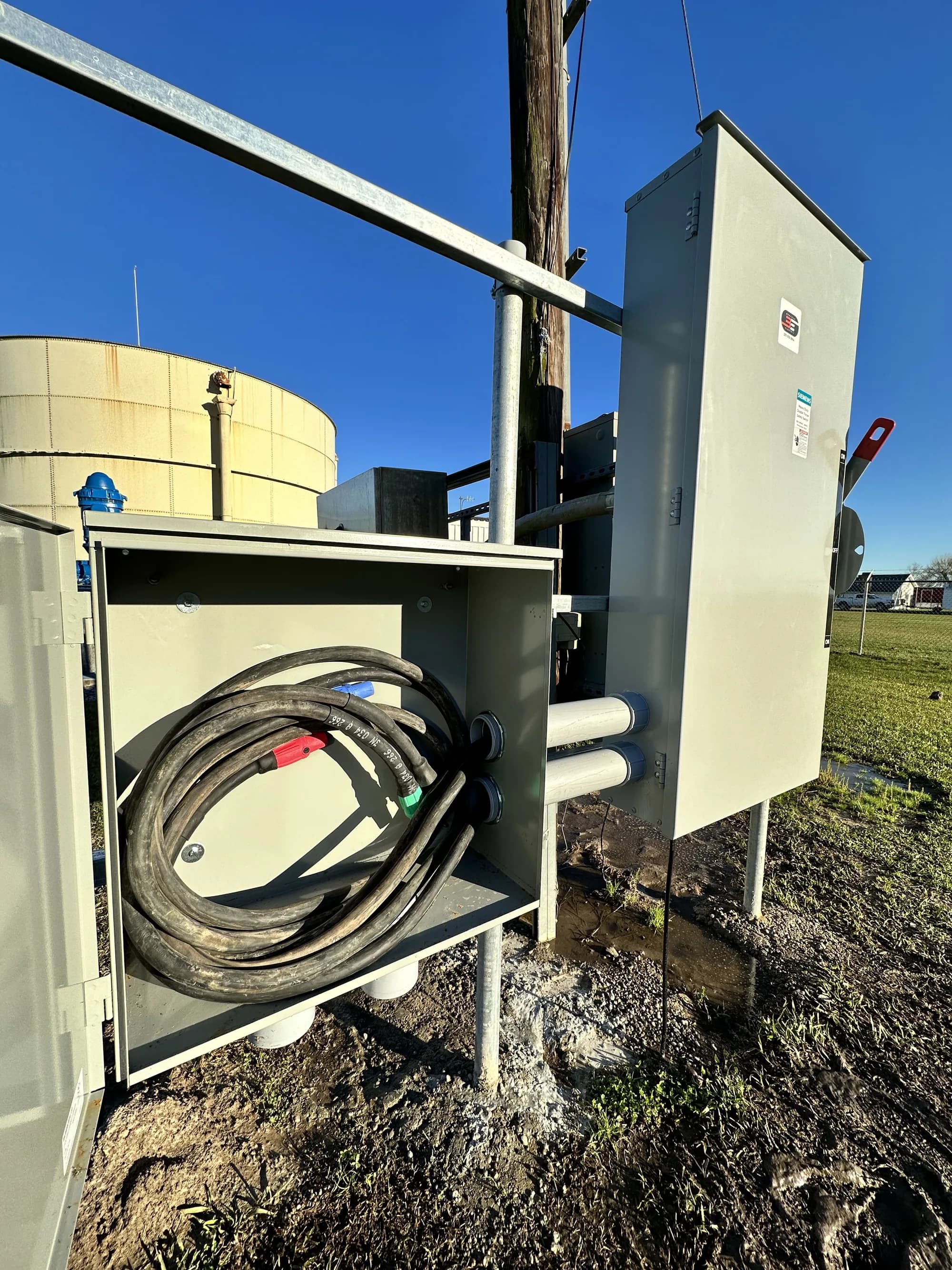 Open electrical disconnect with exposed fuses and wiring — emergency repair