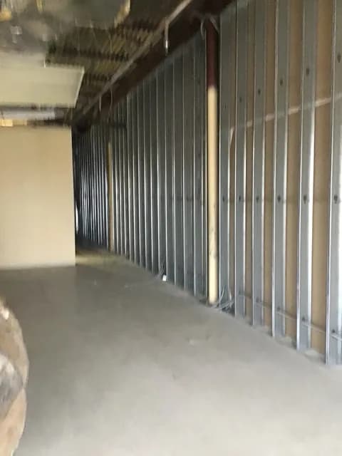 Long run of EMT conduit cleanly fastened to steel-stud framing