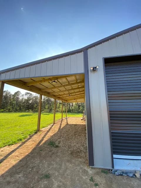 Sunny exterior view of the shop awning, wide grass field beyond