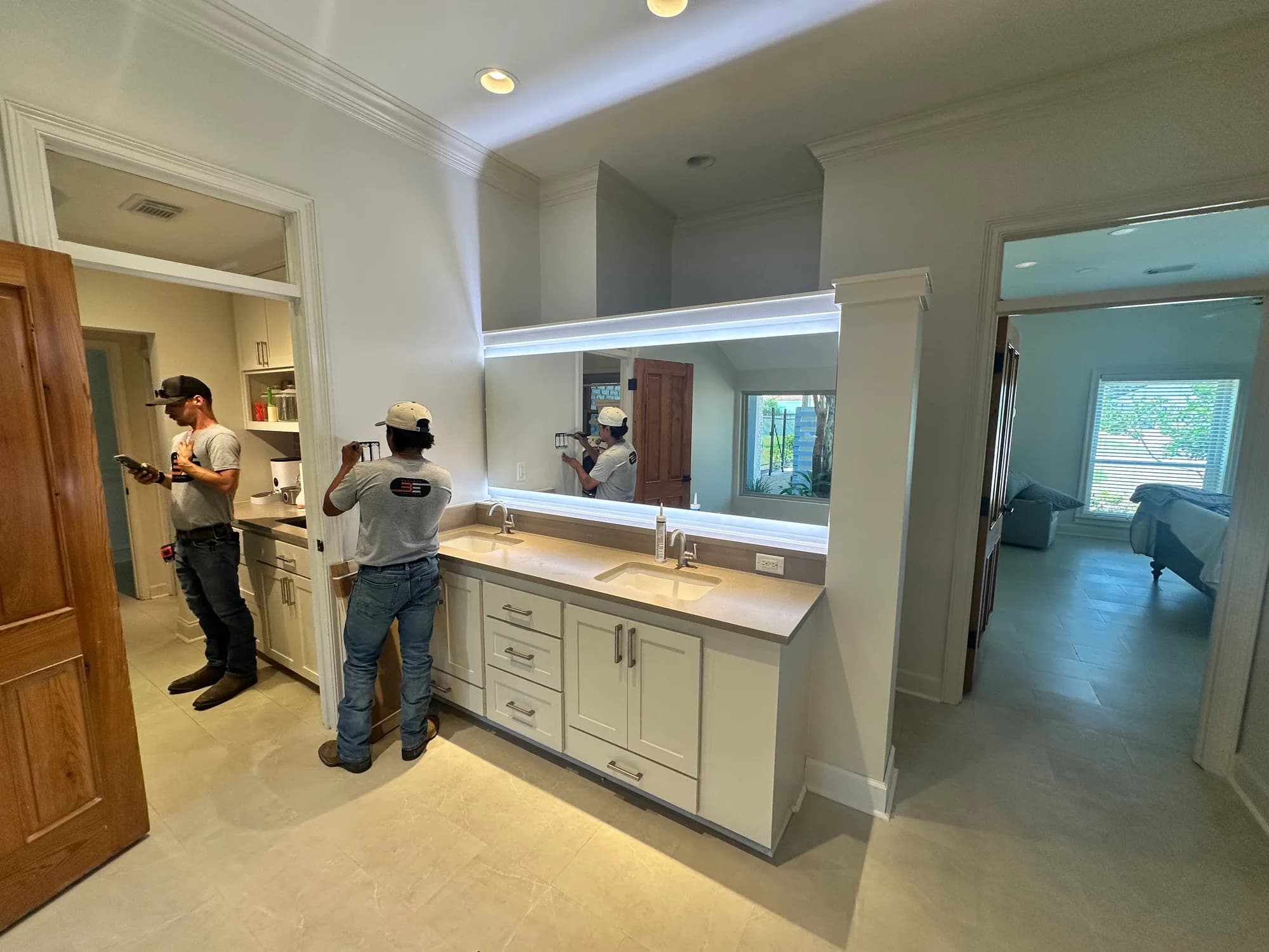 Babcock Electric crew installing a backlit color-tunable vanity mirror